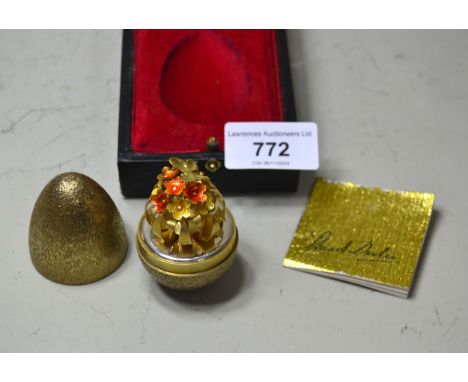 Stuart Devlin, Limited Edition silver gilt egg form trinket box, the cover opening to reveal a floral display, No. 233 from a