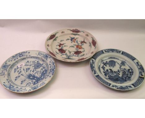 Two antique blue and white delftware plates, 30cm diameter, together with a polychrome delftware plate, 33cm diameter (damage