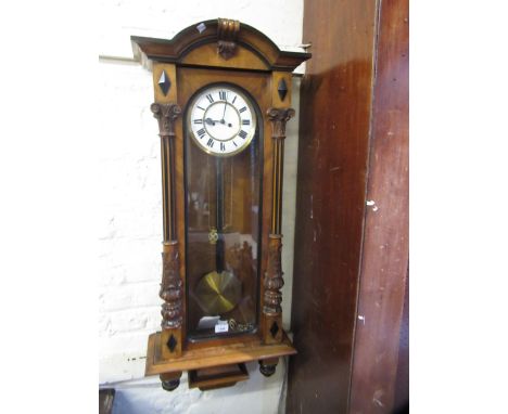 Late 19th Century walnut Vienna wall clock, the enamel dial with Roman numerals, the two train weight driven movement strikin