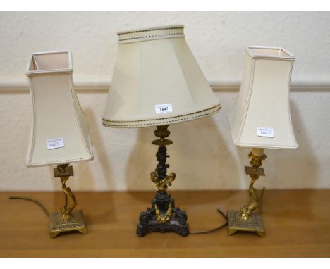 19th Century dark and gilt patinated bronze candlestick adapted for use as a table lamp and a pair of dolphin table lamps
