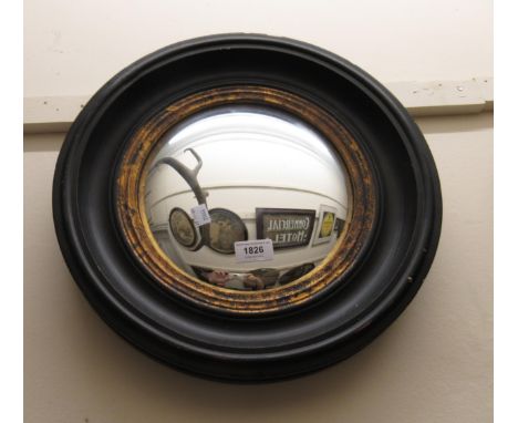 Circular reproduction ebonised and gilt convex  wall mirror, 40cm diameter, together with an early 20th Century oak aneroid b