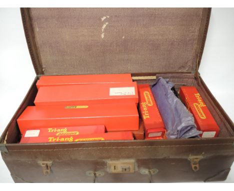 Brown suitcase containing a quantity of Tri-ang 00 gauge boxed engines, rolling stock etc., including City of Nottingham engi