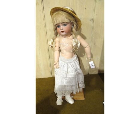 Simon &amp; Halbig, bisque headed doll with sleeping eyes and open mouth with four teeth on a jointed composition body, with 