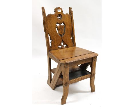 19th Century oak metamorphic library step / chair having pierced carved shield shaped back, on shaped carved front supports