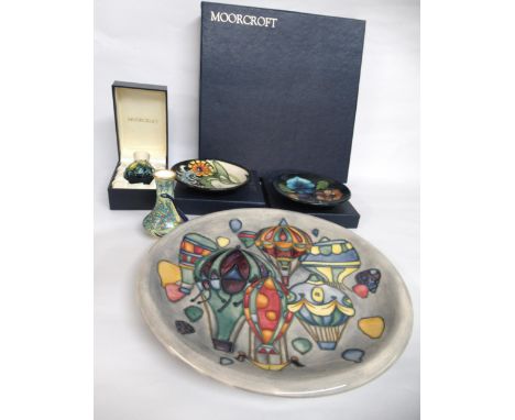 Moorcroft plate decorated with air balloons, in original box, two smaller boxed Moorcroft plates, another Moorcroft miniature
