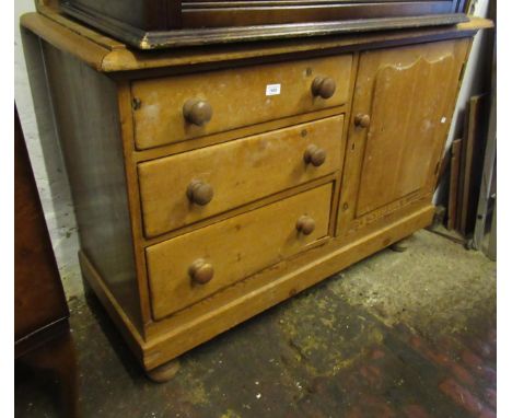 19th Century stripped pine side cabinet with a low shelf back above three drawers beside a cupboard door, on turned supports,