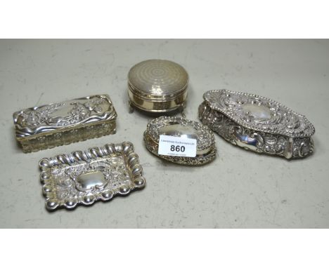 Two embossed silver dressing table boxes, circular silver trinket box, silver mounted glass trinket box, and a small silver t