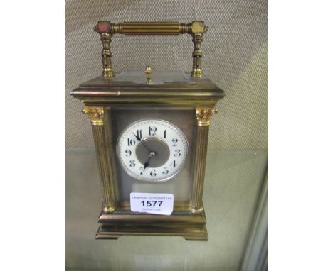 Early 20th Century gilt brass carriage clock, the circular ceramic dial with Arabic numerals with a half hour repeat two trai