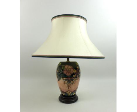A Moorcroft Pottery Oberon pattern table lamp, of ovoid form with circular wooden base and complimentary Moorcroft shade, lam