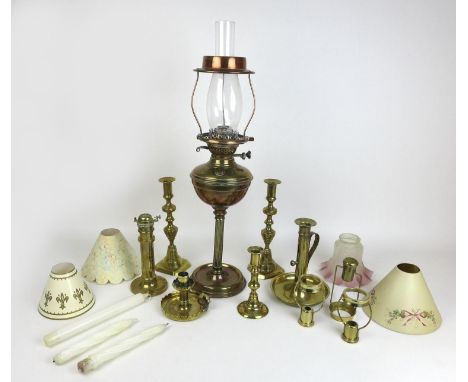 A collection of brass candlesticks, including an unusual 19th century sprung ejector example with later pink glass shade, 19.