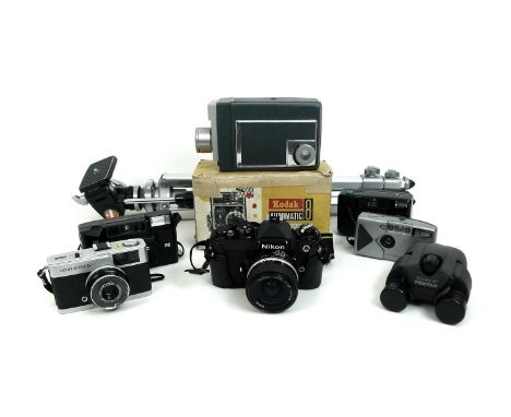 A group of vintage cameras, including a Nikon, an Olympus Trip 35, a Kodak Automatic Super 8 cine camera, boxed, a tripod, an