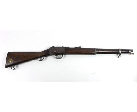 A Victorian Martini Henry carbine, with broad arrow stamped on its stock as well as to its barrel, a brass inset disc stamped