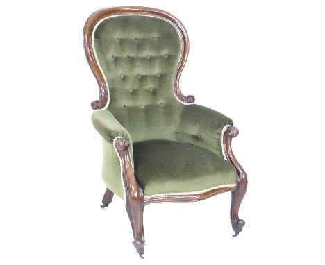 A Victorian mahogany spoon back armchair, moulded frame and scroll arm ends, upholstered in green button back velvet, with ca