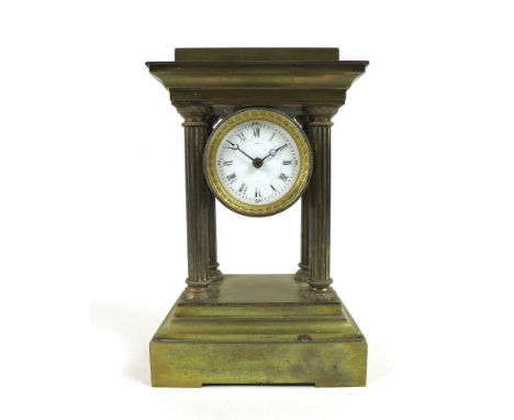 A Victorian brass mantel clock, of architectural form, the white enamel 1.75" dial with black Roman numerals housed in a cyli