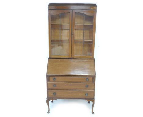 A mid 20th century mahogany bureau bookcase, twin glazed doors enclosing two fixed shelves, fall front with fitted interior o