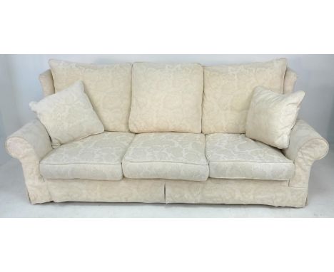 A modern large three seater sofa, of wingback style, upholstered in cream foliate cotton, 220 by 97 by 90cm high, together wi