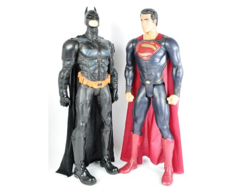 Two large ex shop display / advertising half-scale action figures of the DC Universe Batman and Superman. Both with capes and