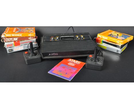 An original vintage black Atari 2600 retro gaming video games console model No. CX-2600, x2 controllers, power lead and eight