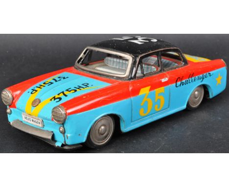 A vintage believed Japanese made tinplate friction motor Volkswagen challenger car. Colourful red blue and yellow painted bod