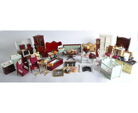 A large collection of assorted dolls house furniture to include; wooden tables, book cases, sofas, chairs, wardrobes, cabinet