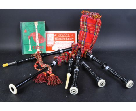 A set of original vintage children's Logan's Scottish Highland bagpipes. Usual form with tartan bag, drone, blowpipes and cha