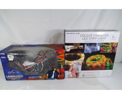 A Winplus colour changing LED strip light, indoor and outdoor 5 mtrs in length and an American Chopper Christmas bike from Th