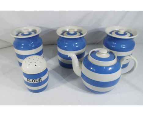 Five pieces of T G Green blue and white Cornish ware to include three large lidded jars, a teapot and a flour sifter, largest