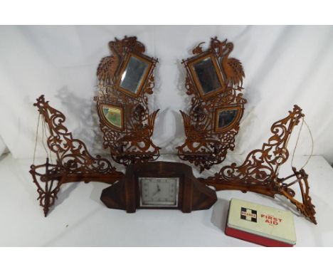 A pair of fretwork wall hangings, wood cased clock and vintage first aid kit.