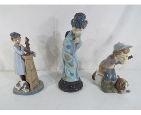 Lladro - three Lladro figurines comprising #4971 Hunter Puppet, #4989 Japanese Sayonara and #5358, stamped and impressed mark