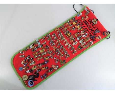 A felt roll containing a quantity of Robertson's golly enamel pin badges, approx 95 badges in total 