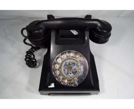 A vintage black Bakelite telephone Est £20 - £40