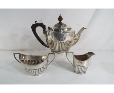 A George III hallmarked silver teapot, sugar bowl and creamer, Birmingham assay, approximate weight 559 grams