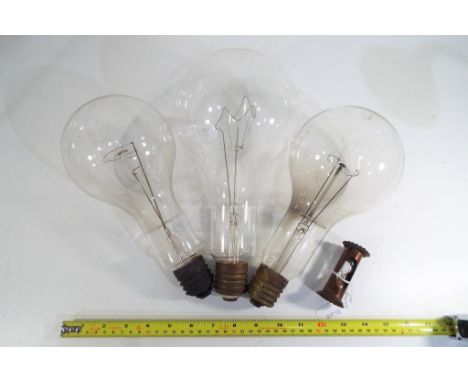Three large early period Mazda electric light bulbs, approx 28 cm (length) and an early period egg timer 