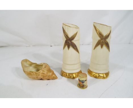 Royal Worcester - four pieces of blush ivory Royal Worcester to include a pair of small bud vases, approximately 10 cm (h), a