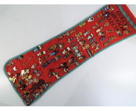 A felt roll containing a quantity of Robertson's golly enamel pin badges, approx 68 badges in total 