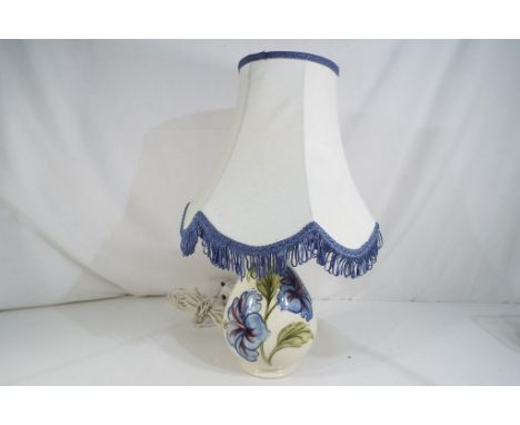 Moorcroft Pottery - a Moorcroft Pottery lamp base decorated with blue hibiscus, impressed marks to the base with matching lam