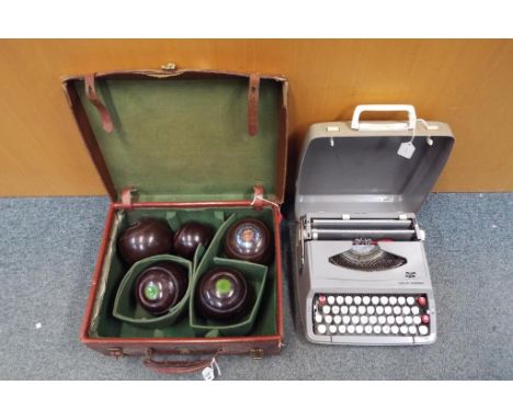 A vintage case containing two Crown Green bowls approximately 2.6 lbs and two flat green indoor bowls approximately 3 lbs, al