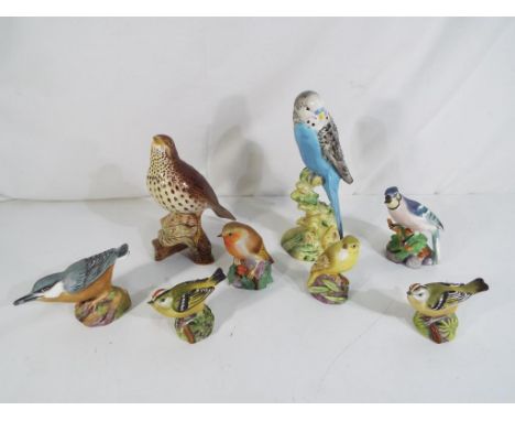 A lot to include two Beswick bird figurines to include #2309 Song Thrush impressed marks to the base and six Royal Worcester 