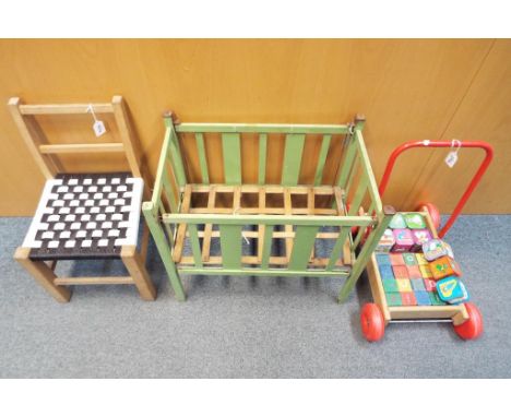 A lot to include a child's push-along trolley containing building blocks, small vintage doll's cot and a child's chair (3)