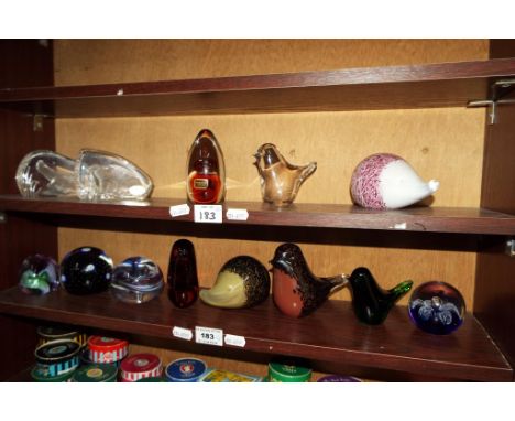 Two shelves of glass paperweights by Caithness, Wedgwood and similar (2 shelves). 