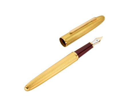Kurt Weiss. An 18ct gold mounted fountain pen  Engine turned barrel, Montblanc nib and piston, London hallmarks, 1995 14cm le
