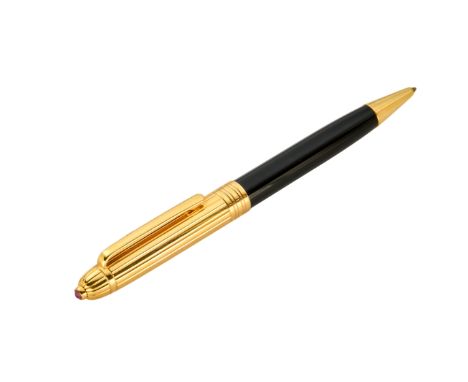 A gold and ruby set ballpoint pen Black resin barrel and gold cap with a cabochon ruby terminal, Montblanc cartridge 14cm app
