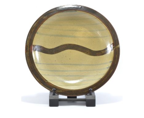 LEACH POTTERY; a stoneware dish with wavy line decoration, impressed SI mark, diameter 31.5cm.   CONDITION REPORT:  Appears g