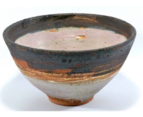 ROBIN WELCH (born 1936); a stoneware footed bowl with bands of black and lilac glaze, impressed RW mark, diameter 22.5cm.   C