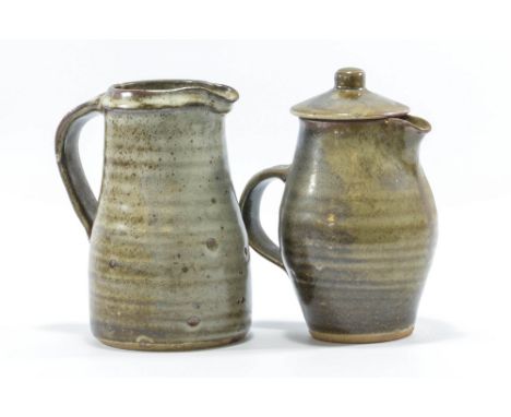 LEACH POTTERY; a stoneware coffee pot covered in mottled dark green glaze and a water jug covered in mottled grey/brown glaze