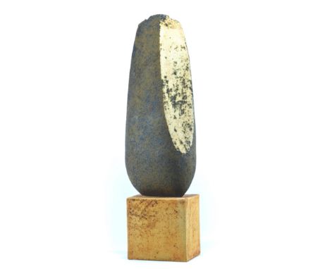NIGEL EDMONDSON; a stoneware sculpture in the form of a prehistoric hand axe, mounted on a hollow cube base, height (includin