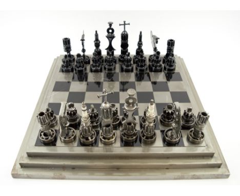 CHESS SET, the pieces made from vehicle and machine parts, plus a steel chequer board(scratches to board).