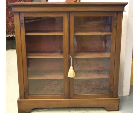 BOOKCASE, late Victorian mahogany with two glazed doors enclosing shelves on bracket supports, 107cm W x 112cm H x 33cm D. (w