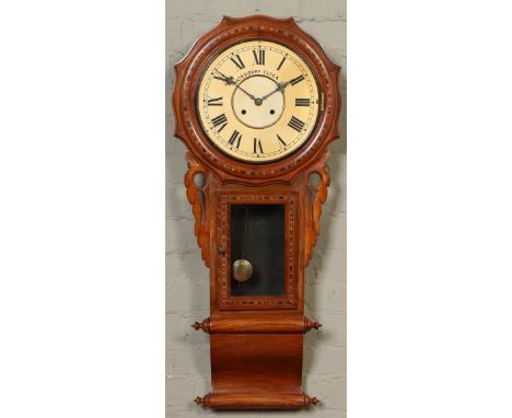 A Victorian walnut cased inlaid eight day drop dial wall clock. With painted dial signed Waterbury Clock Co. Chiming half hou