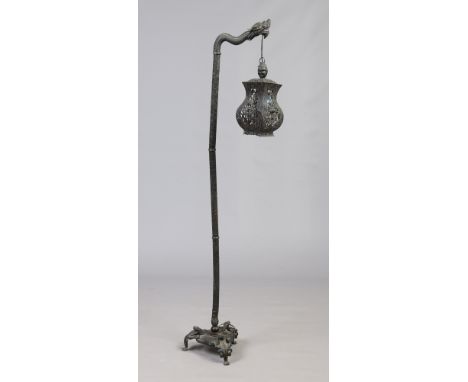 A Japanese bronzed standard lamp formed as a dragon supporting a lantern, 163cm. Condition Report. To be used as a guide only